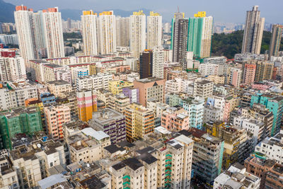 Aerial view of buildings in city against sky