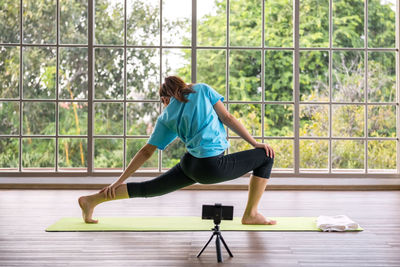 Side view of woman using mobile phone