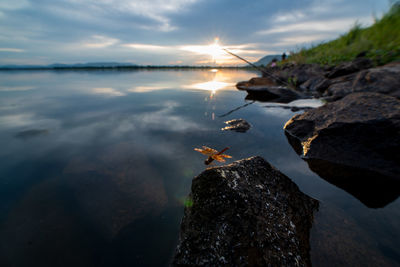 View of rocks in sea against sky