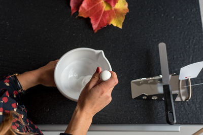 Cropped image of pharmacist preparing medicine using mortar and pestle