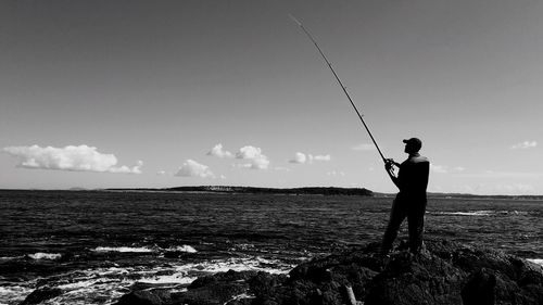 High angle view of man fishing in sea