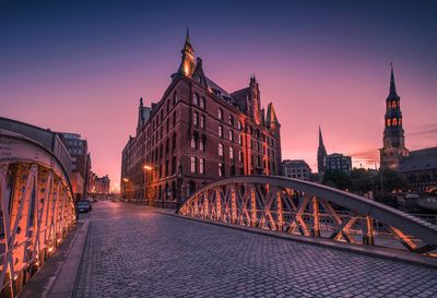 View of bridge and buildings at dusk