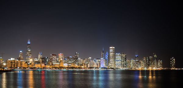 Illuminated city at waterfront