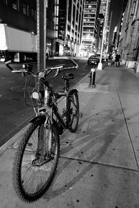 Bicycle on city street by buildings
