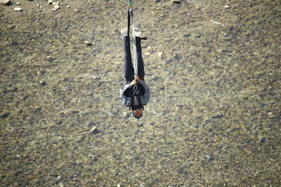 High angle view of man hanging on land