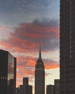 Low angle view of skyscrapers against dramatic sky