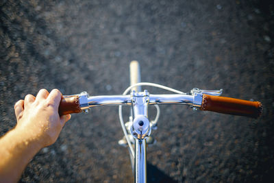 Cropped image of person riding bicycle on road