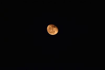 Low angle view of moon against clear sky at night