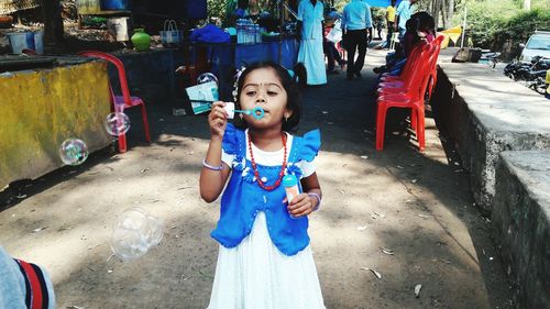 Portrait of smiling girl standing outdoors