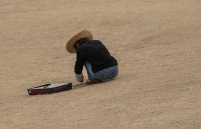 Man wearing hat on sand