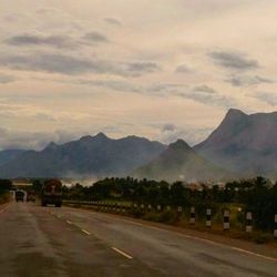 Empty road with mountains in background