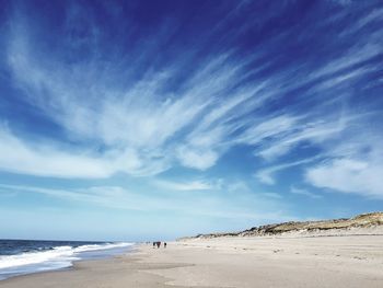 Scenic view of beach against blue sky