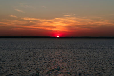 Scenic view of sea against romantic sky at sunset