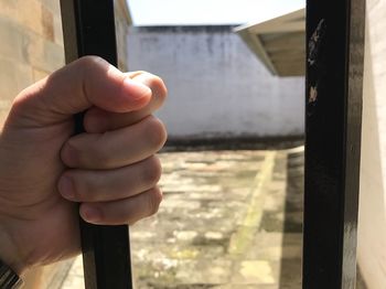 Close-up of hand holding window