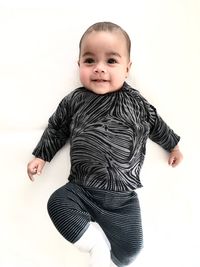 Portrait of cute baby against white background