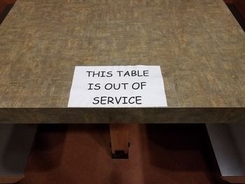 High angle view of information sign on table