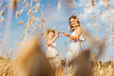 Young woman and plants on field