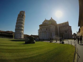People at temple against clear sky