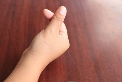 Close-up of person hand on table