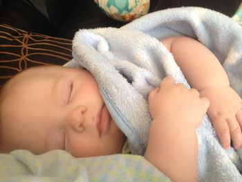 High angle view of baby sleeping in bed