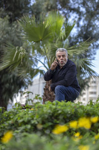 Portrait of man standing against plants