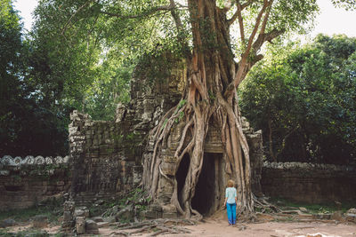 Rear view full length of woman standing outside temple 