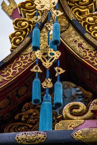 Low angle view of decorations hanging on ceiling of building