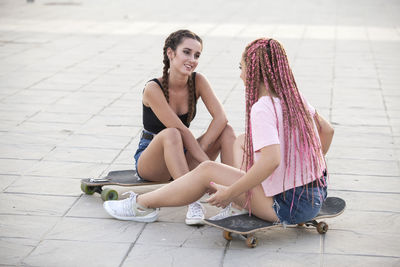 Happy woman sitting on floor