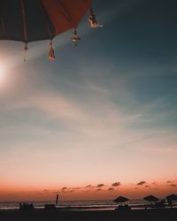 Low angle view of beach against sky during sunset