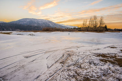 Scenic view of lake against sky during winter