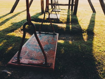 Empty swings hanging at park