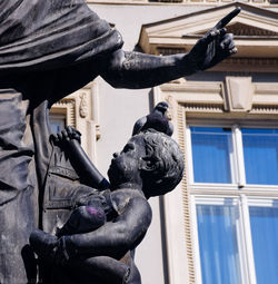 Low angle view of statue against building