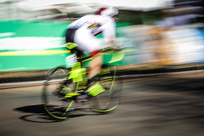 Blurred motion of man cycling bicycle