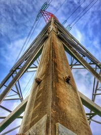 Low angle view of suspension bridge against blue sky