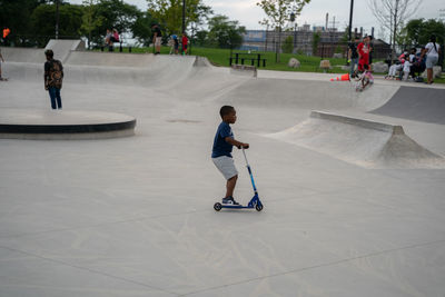 Rear view of boy skateboarding on skateboard