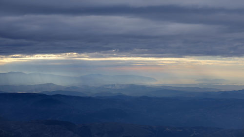 Aerial view of clouds over landscape during sunset