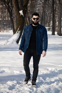 Portrait of bearded man standing outdoors during winter