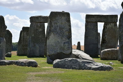 Rocks on field against sky