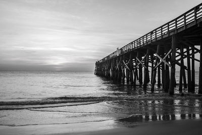 Pier over sea against sky