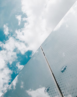 Low angle view of airplane wing against sky