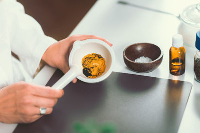 Cropped image of female chef preparing food in commercial kitchen