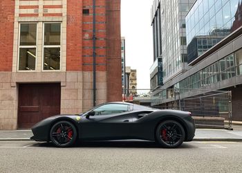 Cars on street by buildings in city