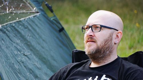 Close-up of man wearing eyeglasses looking away