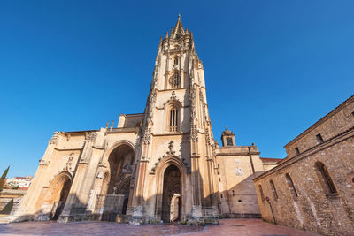 Low angle view of historical building against clear blue sky