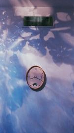 Digital composite image of clock reflection in water