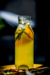 Close-up of yellow glass bottle on table