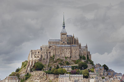 Low angle view of historical building against cloudy sky