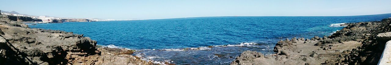 Scenic view of sea against blue sky