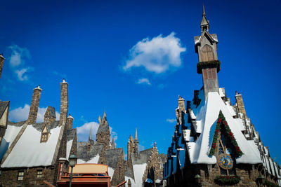 Low angle view of buildings against blue sky