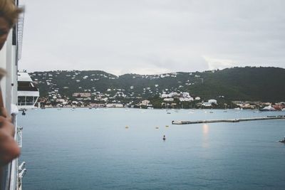 Cropped image of people looking at sea